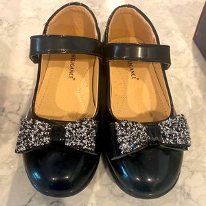 Size 1.5 big kids black dress shoe with sparkle bow and and Velcro strap.